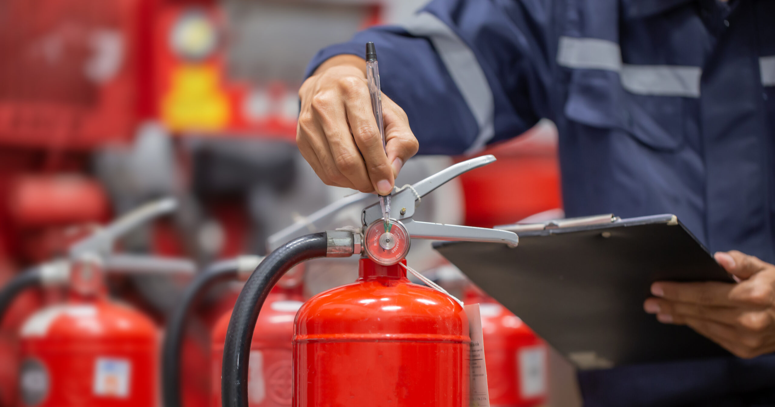 Engineer checks fire extinguisher