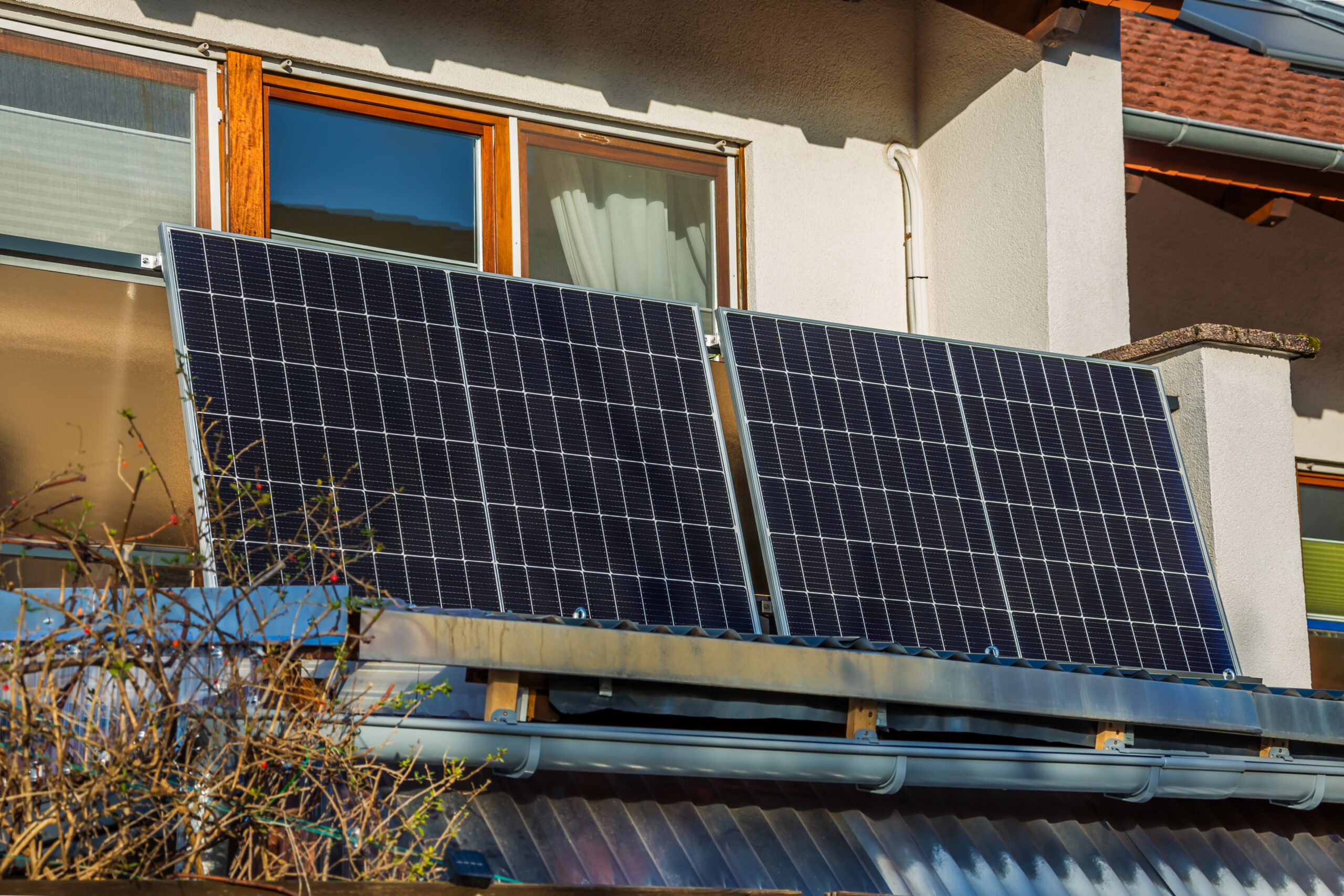 Balcony solar power plant. Solar battery on balcony wall. Mini PV plants generate your own electricity plug play.